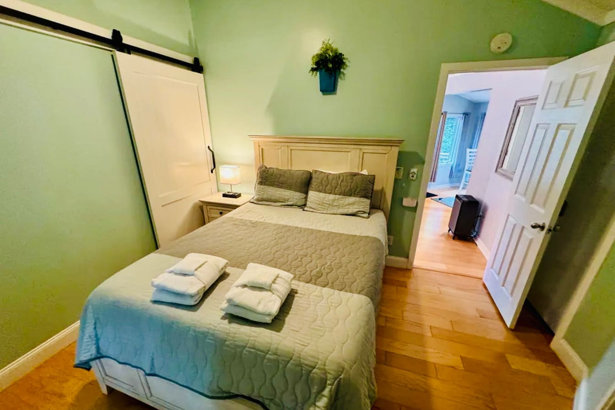 Bedroom with barn door to the bathroom