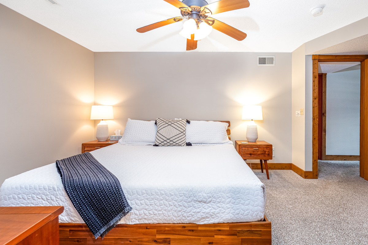 Bedroom 4 featuring a King bed and a Roku Smart TV, and an ensuite bathroom; one of three bedrooms located on the lower level.