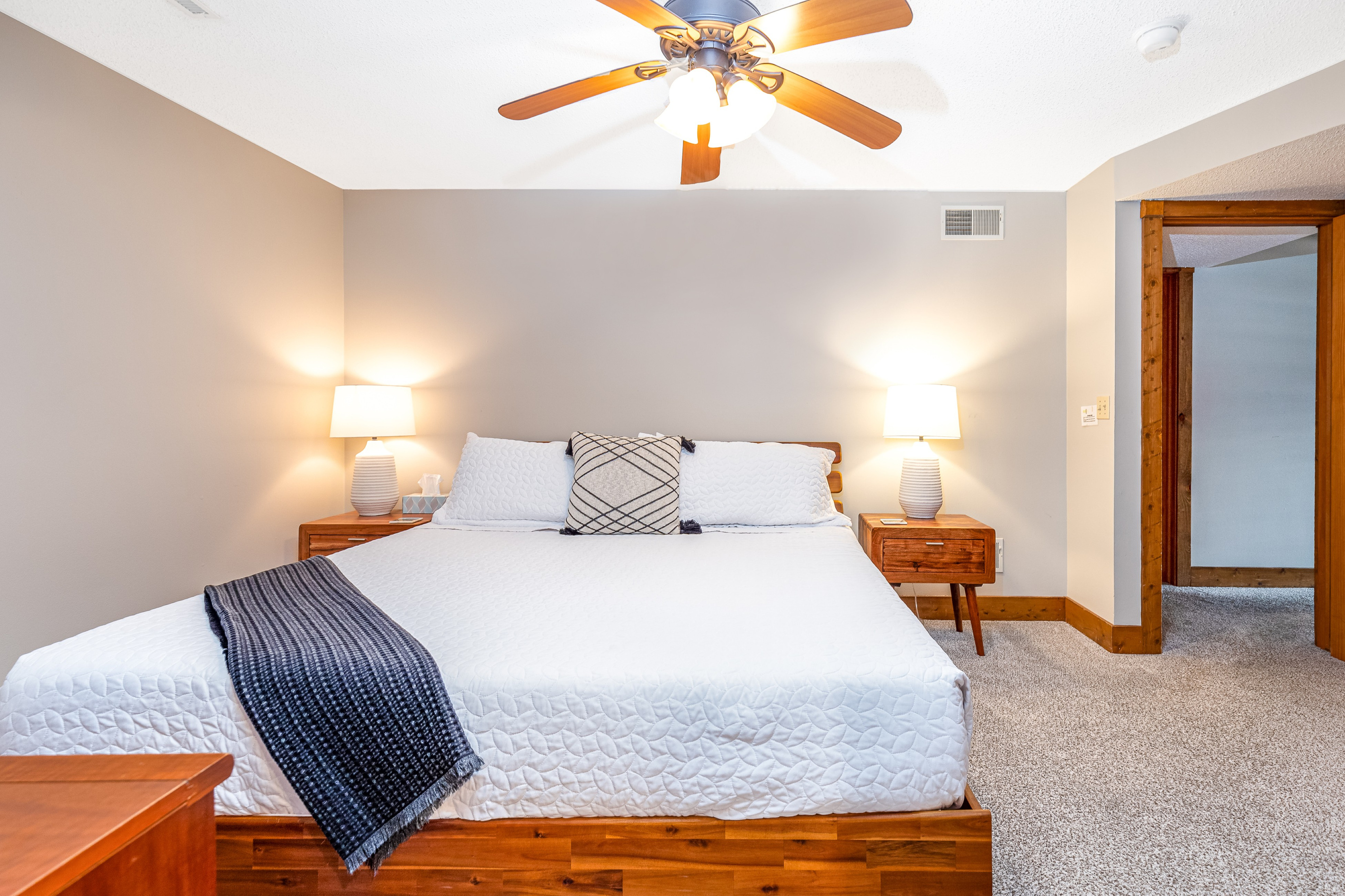 Bedroom 4 featuring a King bed and a Roku Smart TV, and an ensuite bathroom; one of three bedrooms located on the lower level.