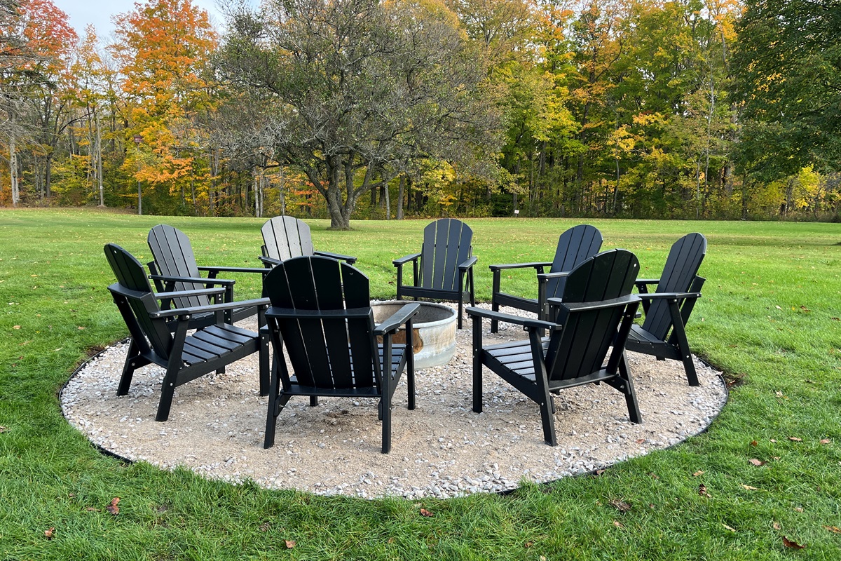 Firepit with Adirondack chairs in the backyard
