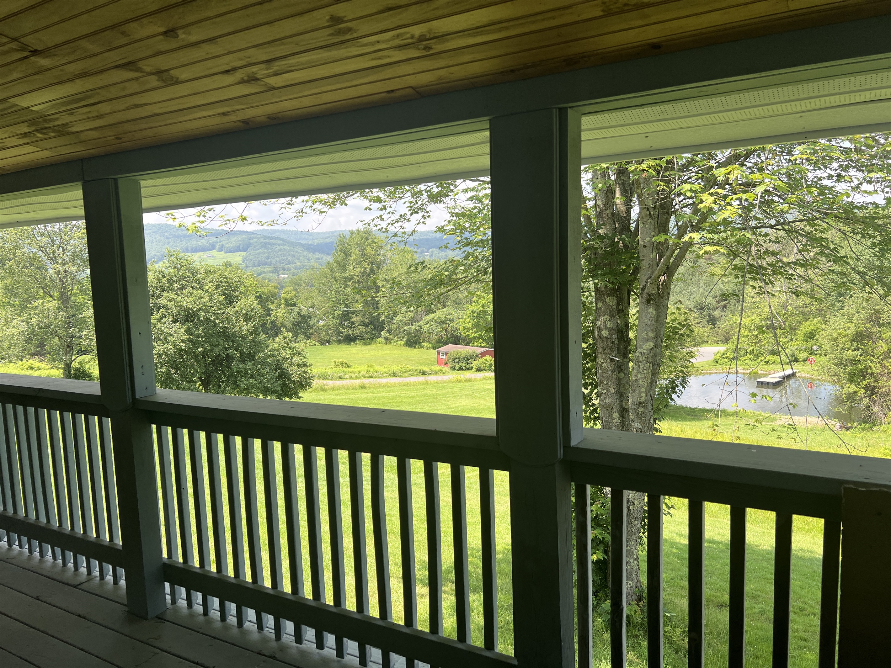 Covered front porch overlooking the pond