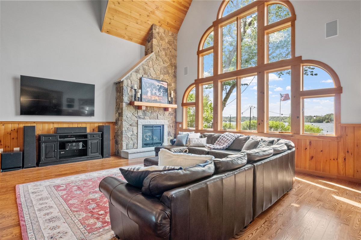 Living room with massive couch, 85" tv, sound system, pool table, and bubble hockey game