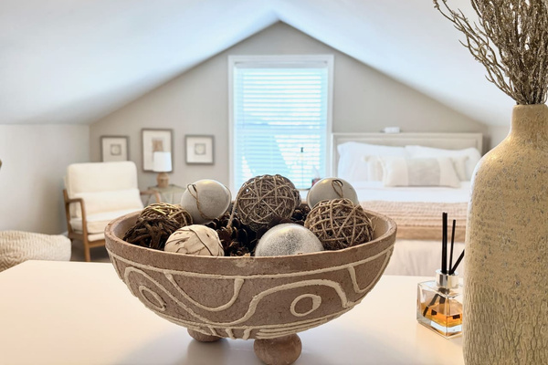 Comfortable bedding and thoughtful details in the main-floor bedroom.