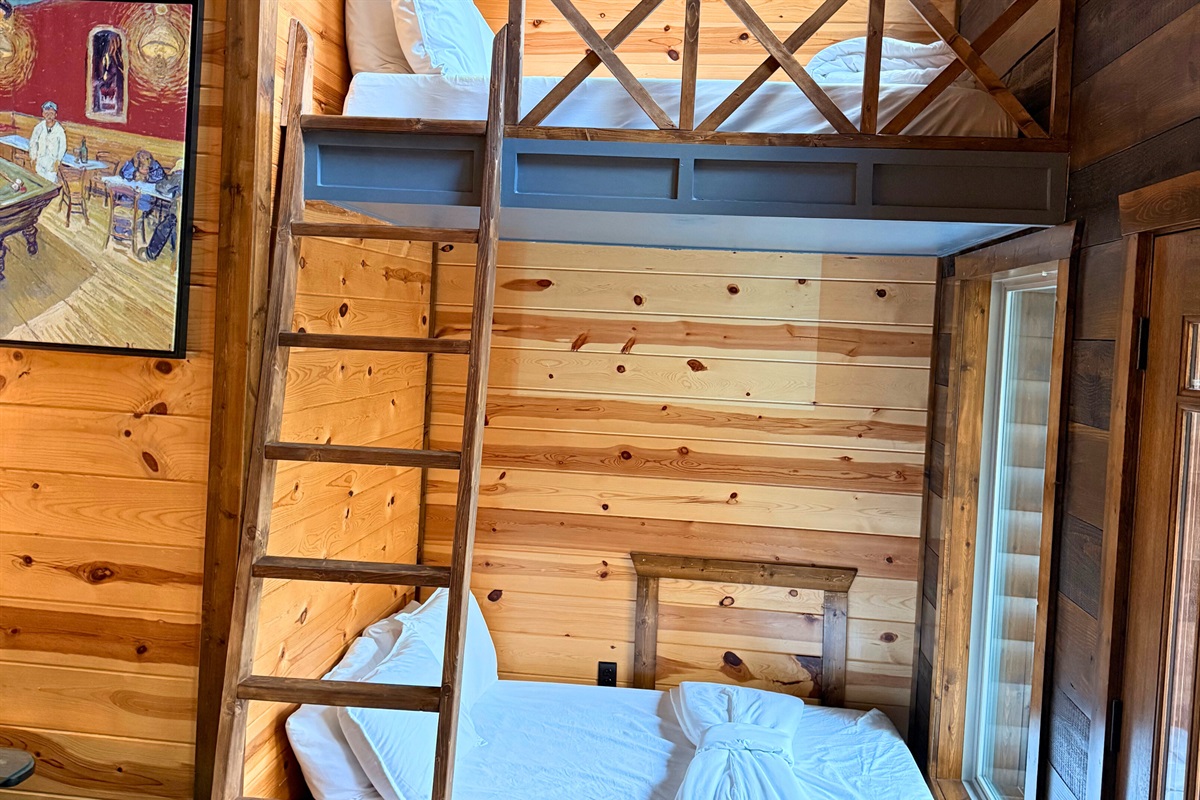 Rustic bunk bed nook framed by natural wood paneling and warm light.