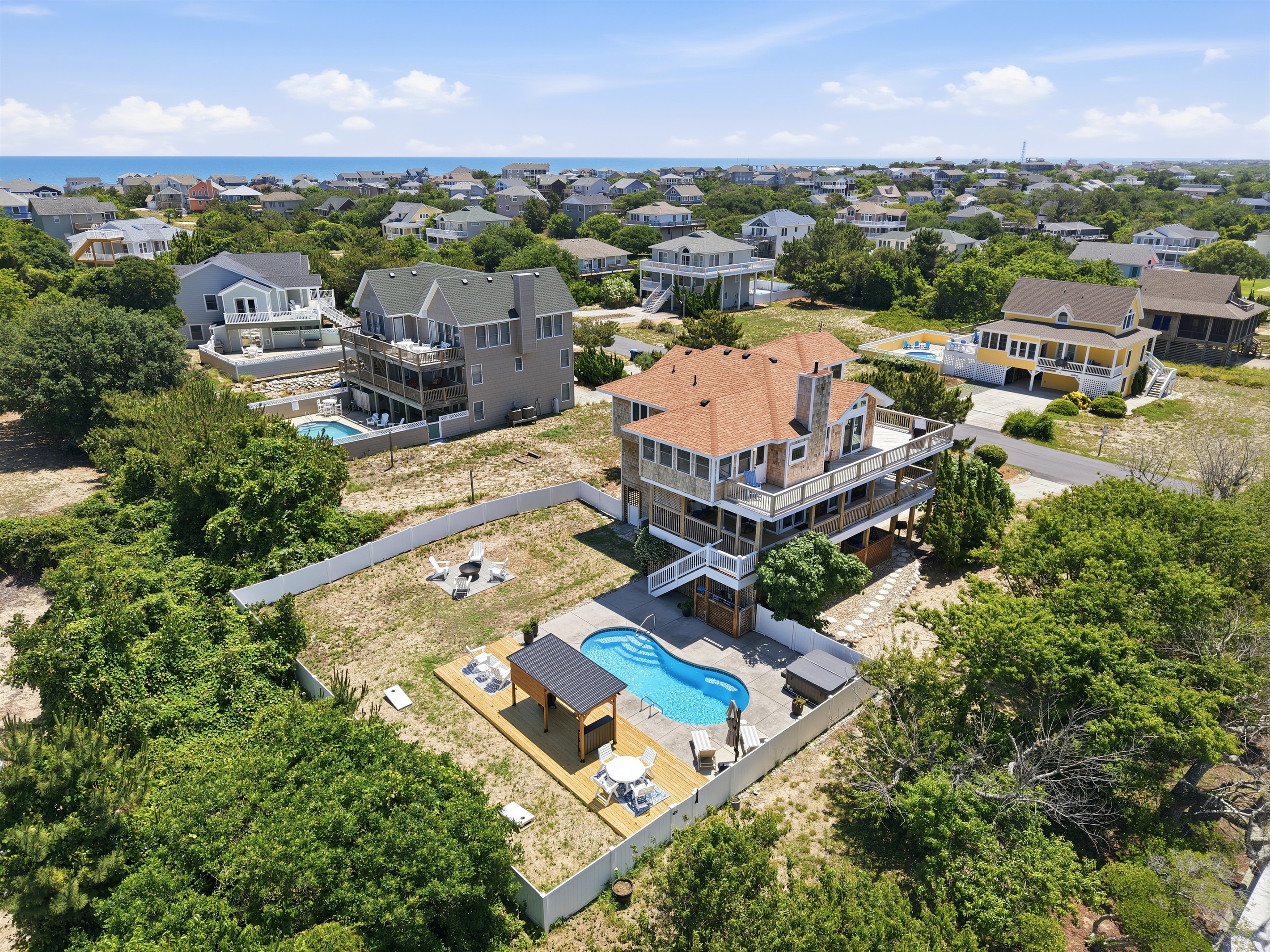 Elevated aerial view showcasing the home and spacious backyard retreat