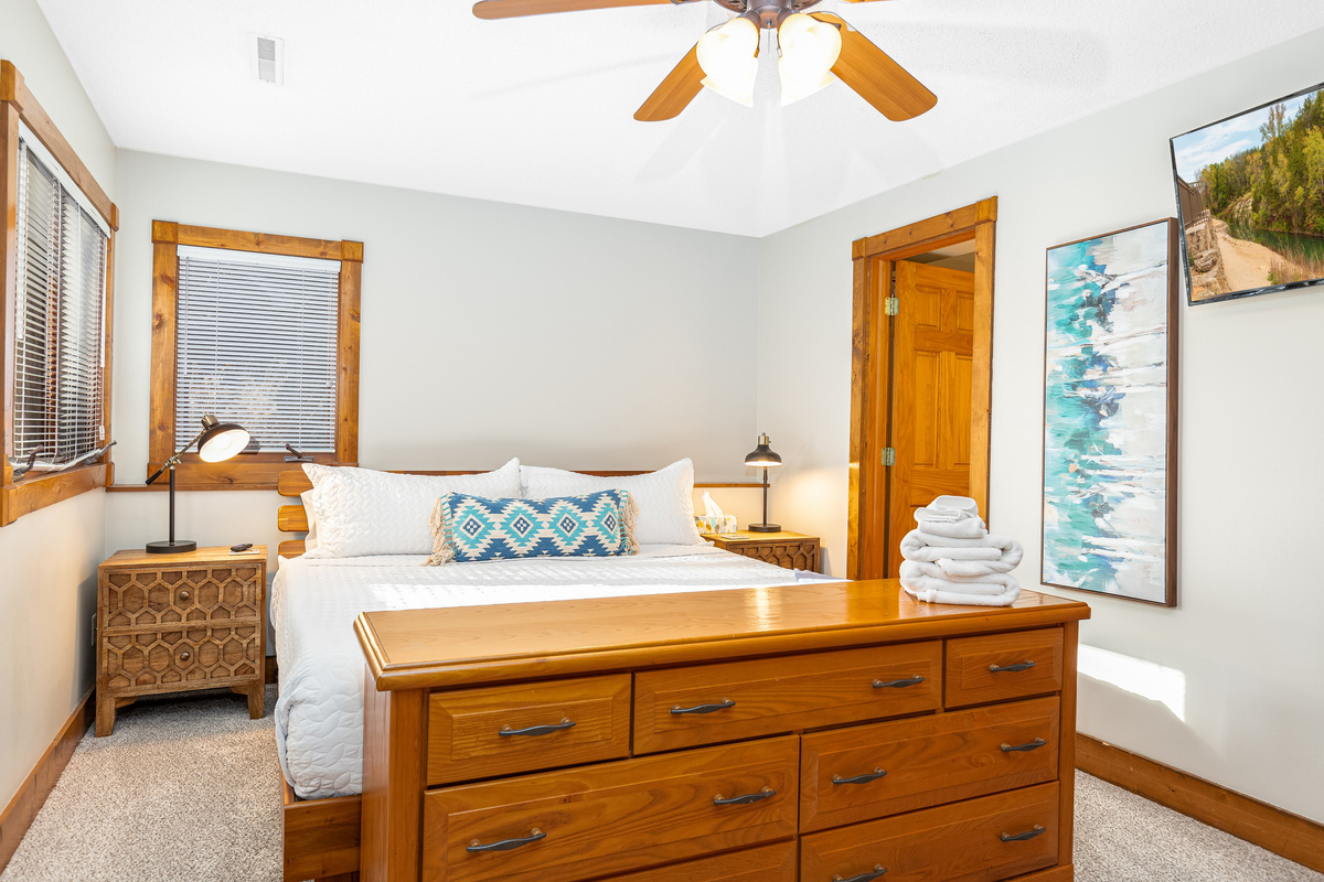 Bedroom 3 featuring a King bed and a Roku Smart TV, and an ensuite bathroom; one of three bedrooms located on the lower level.