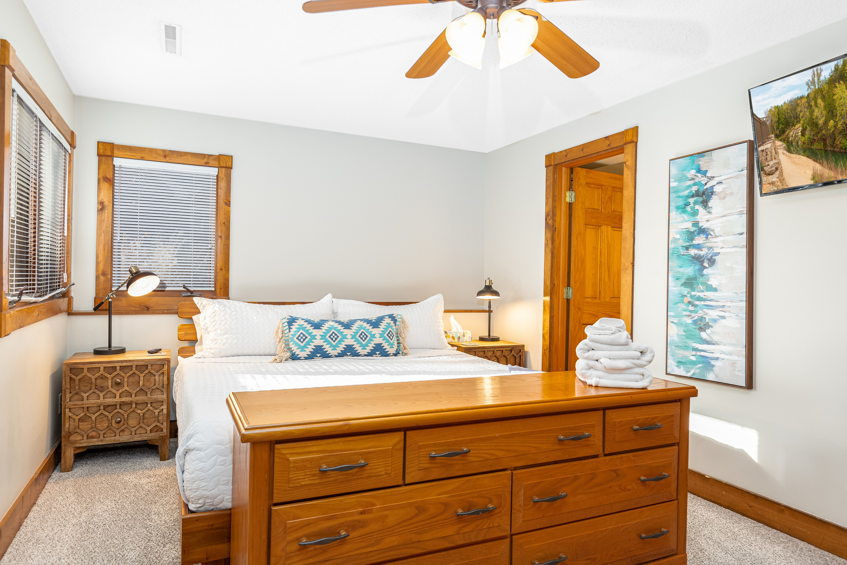 Bedroom 3 featuring a King bed and a Roku Smart TV, and an ensuite bathroom; one of three bedrooms located on the lower level.