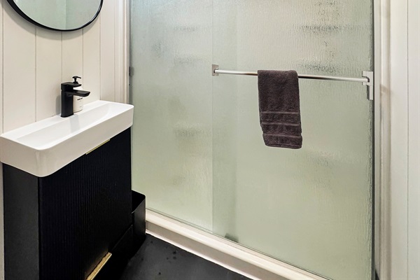 Compact full bath with shower - perfectly functional for your stay.