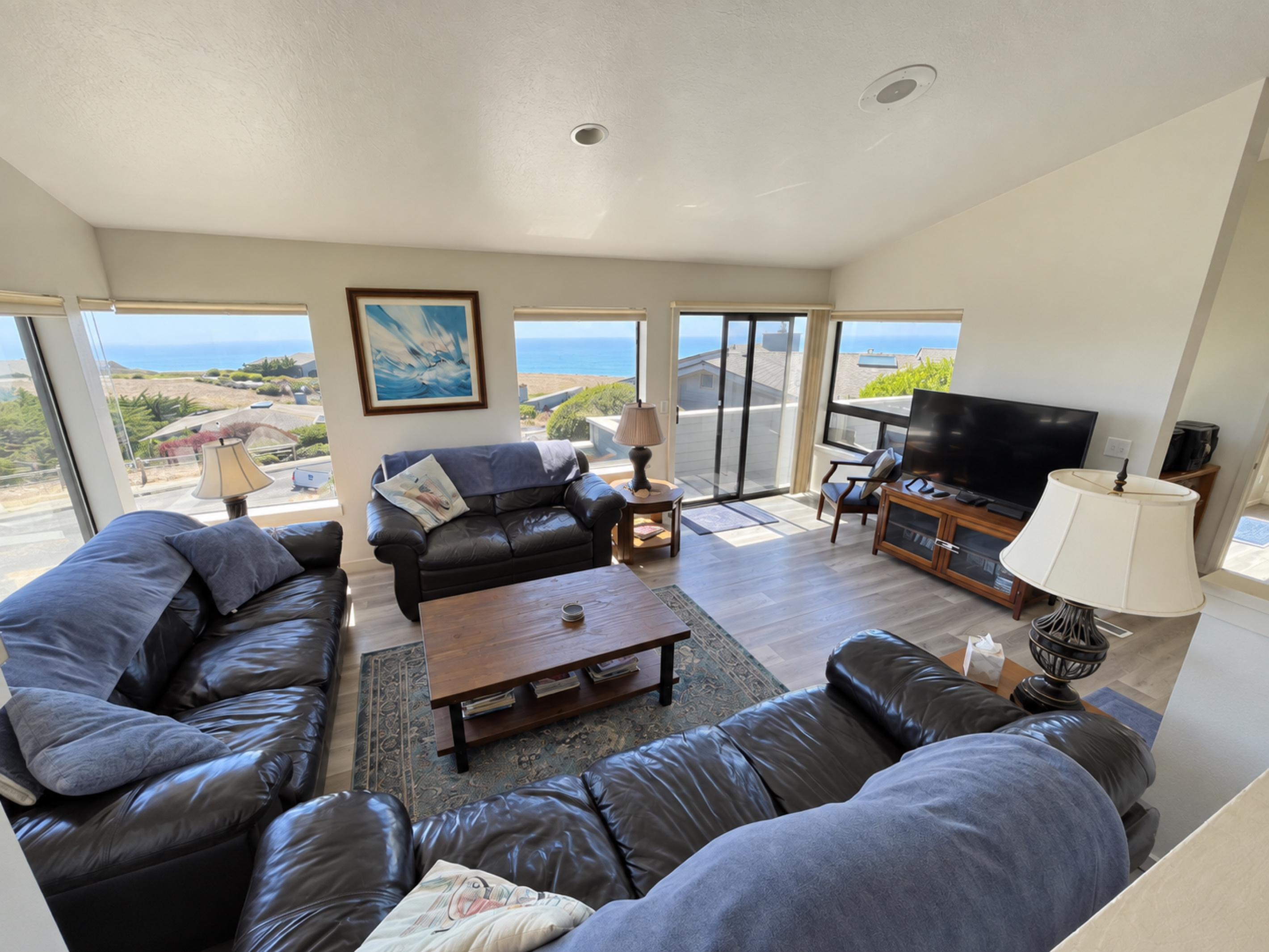 Living Room facing Pacific Ocean. 3 leather Lazy Boy Couches with 55 inch Cable TV/Roku; Blu Ray. Great Ocean Views. Beach Trail across street.