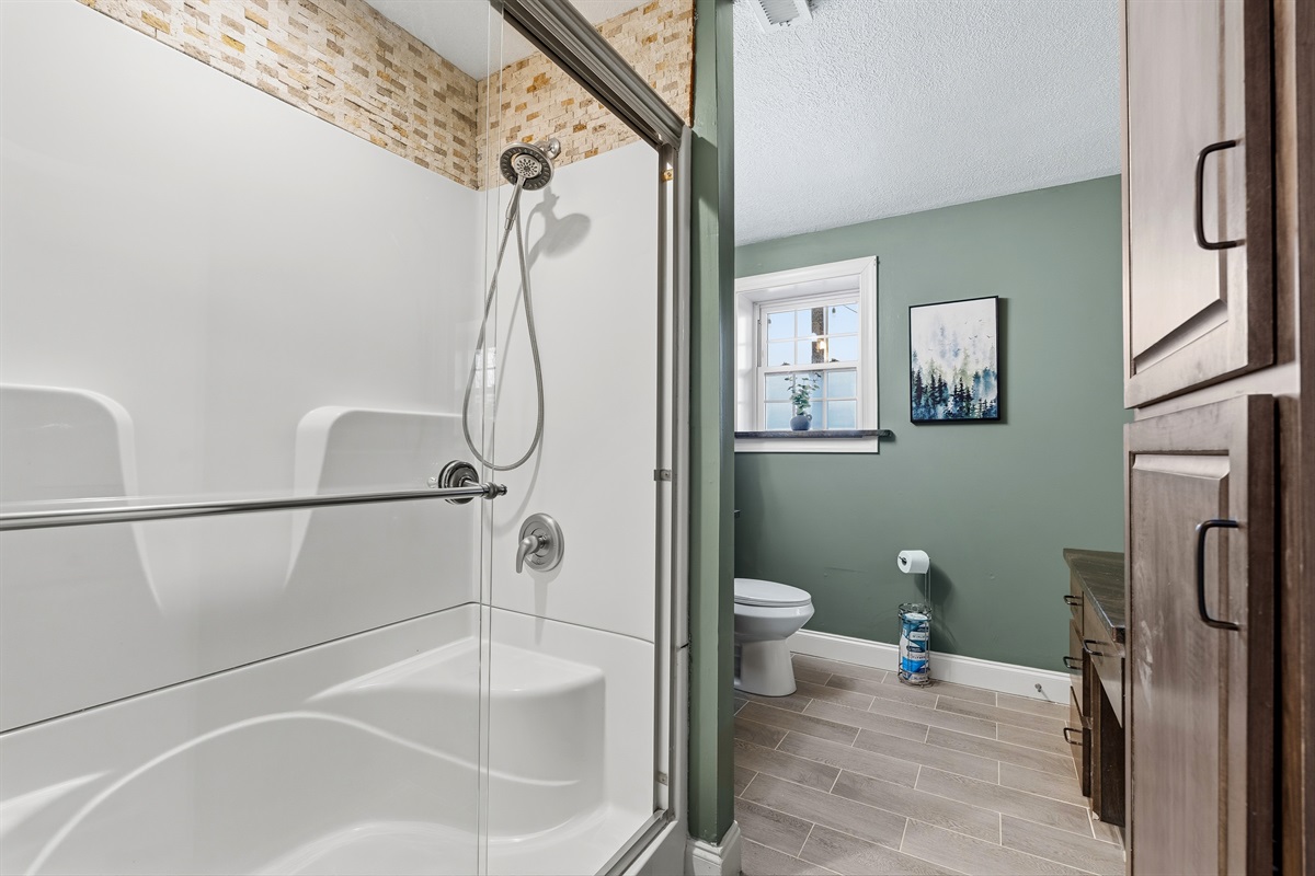 Downstairs bath, accessible from bedroom or main living space. Walk in shower, vanity and makeup counter.