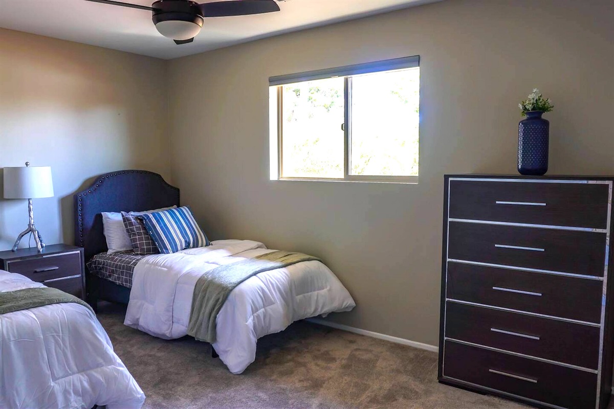 The third bedroom has two twin beds and is tastefully decorated for any age.