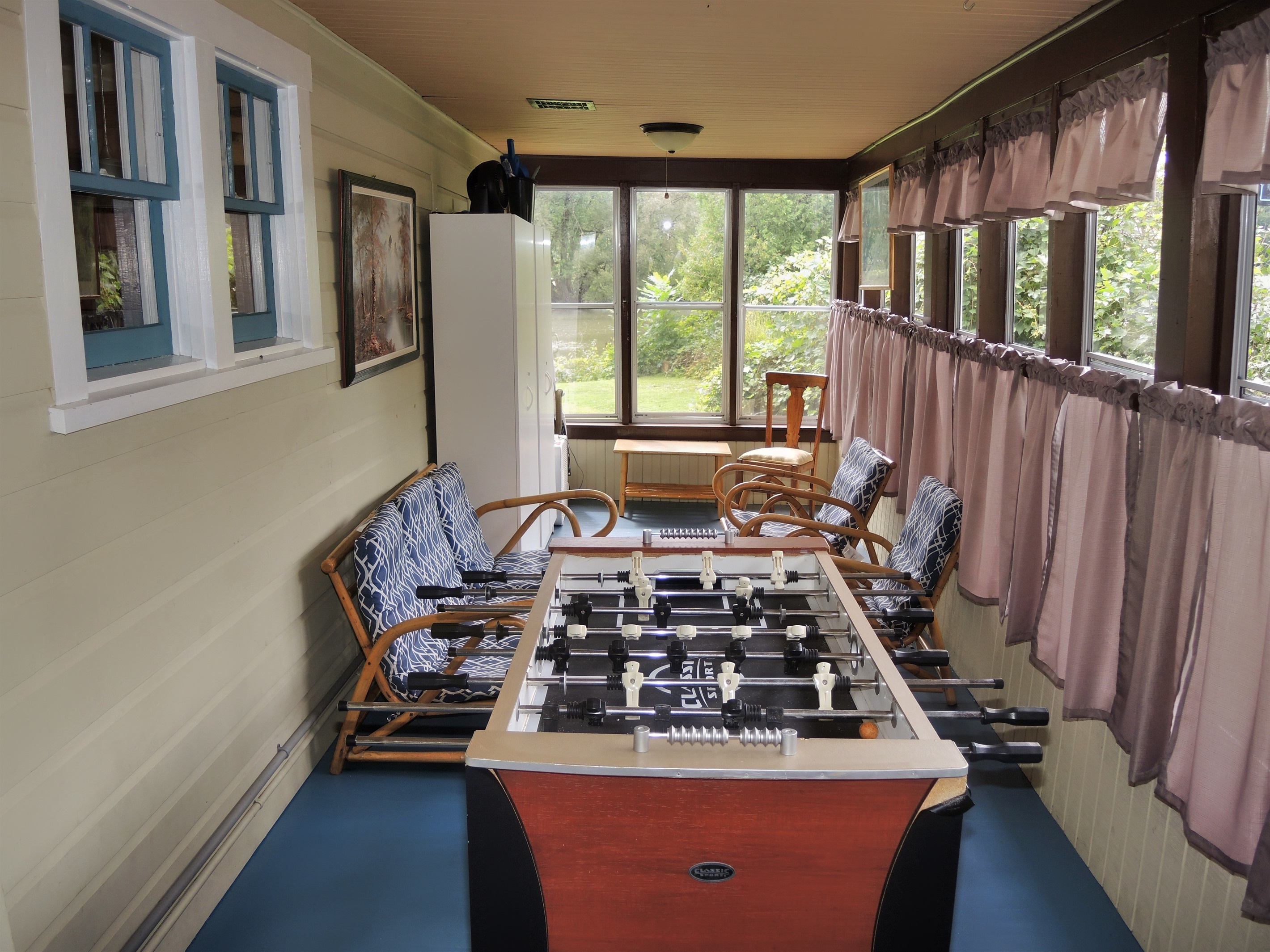 Enclosed side porch with Foosball.
