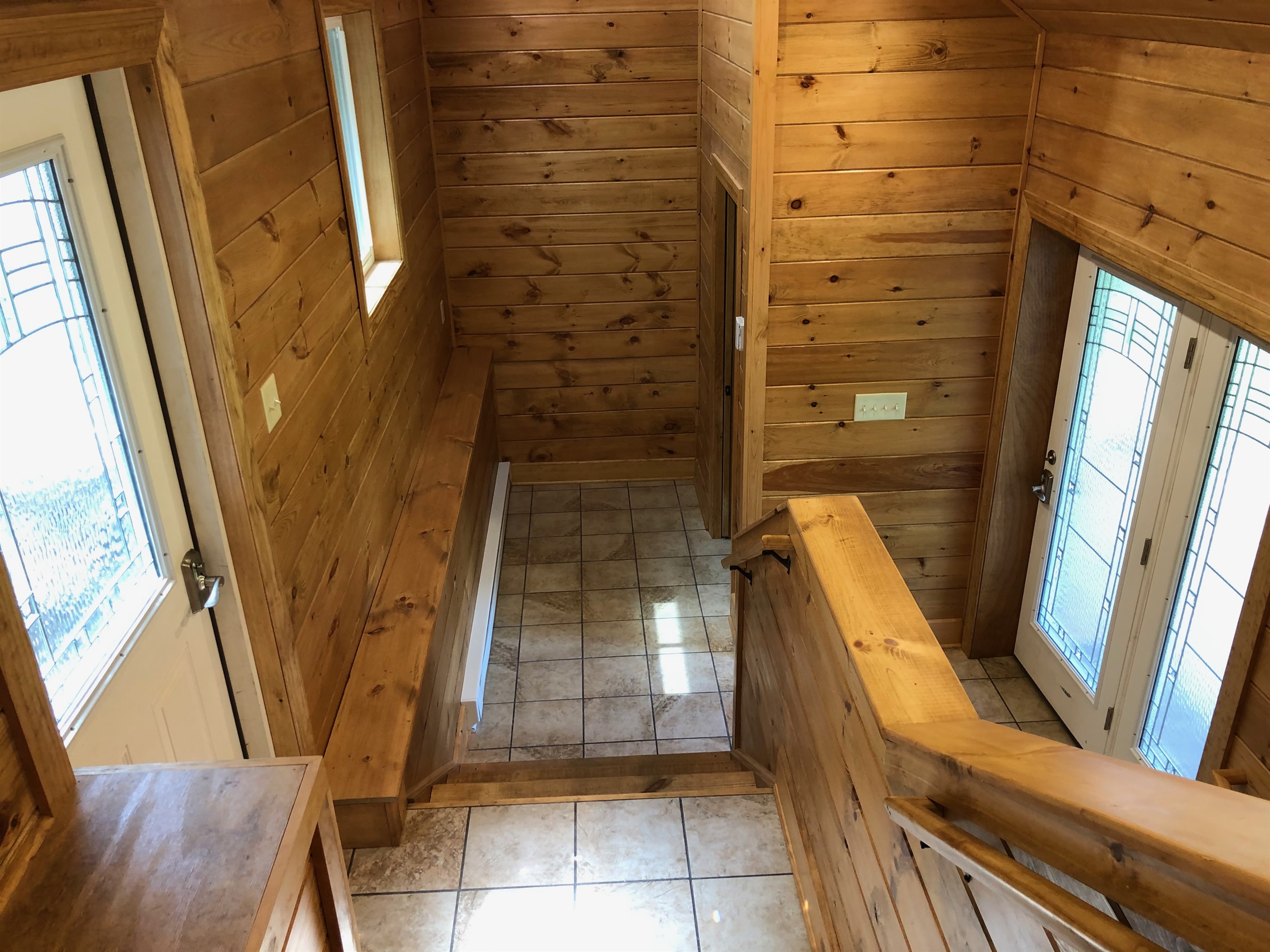 Entry hallway with half bathroom. The door to the left leads outside to private outdoor area.