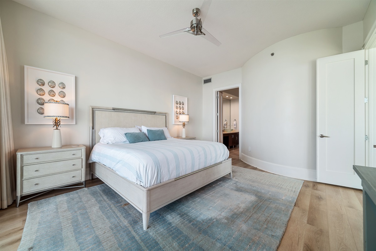 This thoughtfully designed bedroom maximizes natural light and integrates seamlessly with the surrounding environment. The expansive sliding doors and serene color palette create a harmonious and inviting space.
