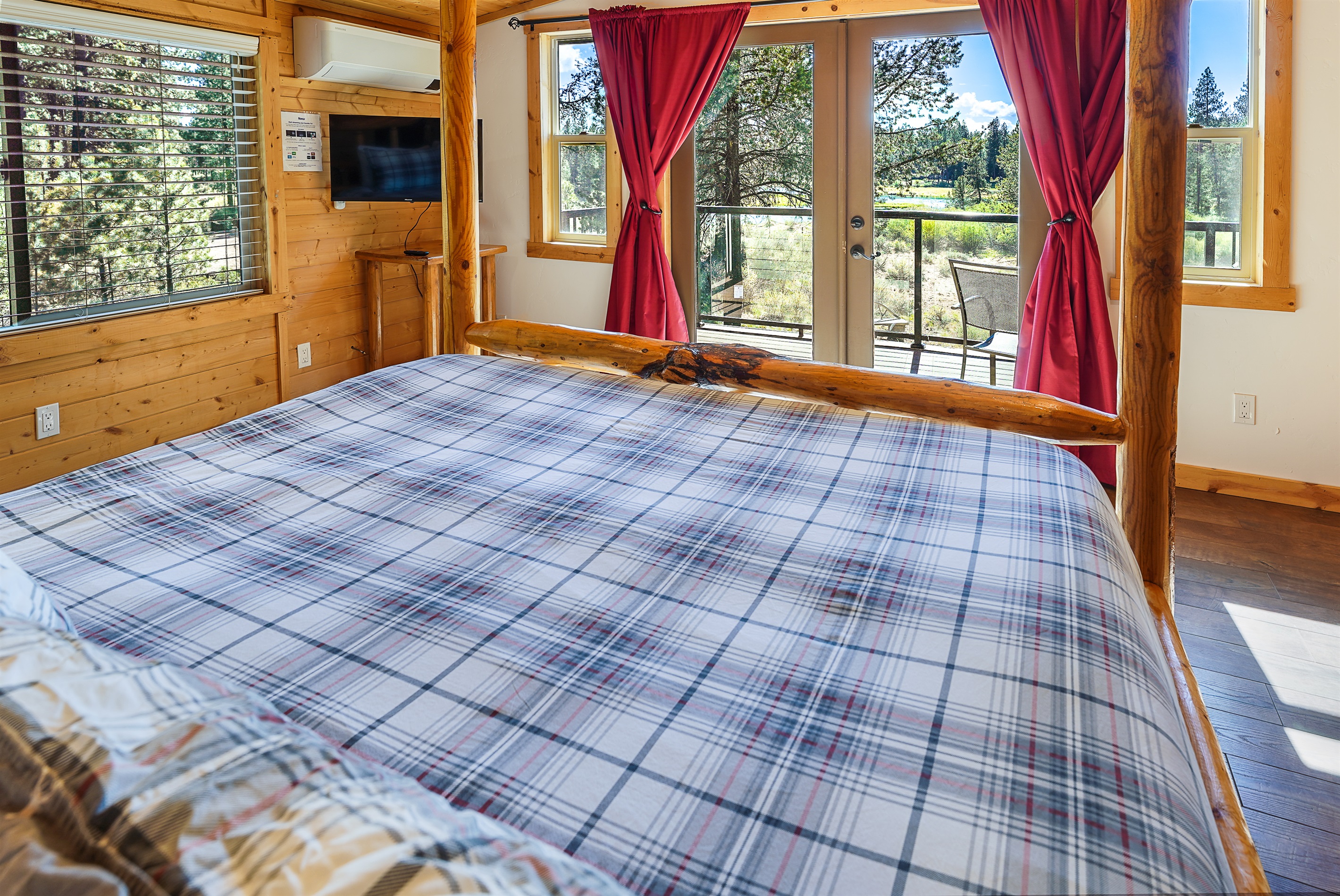 Primary bedroom with river views and peaceful forest setting