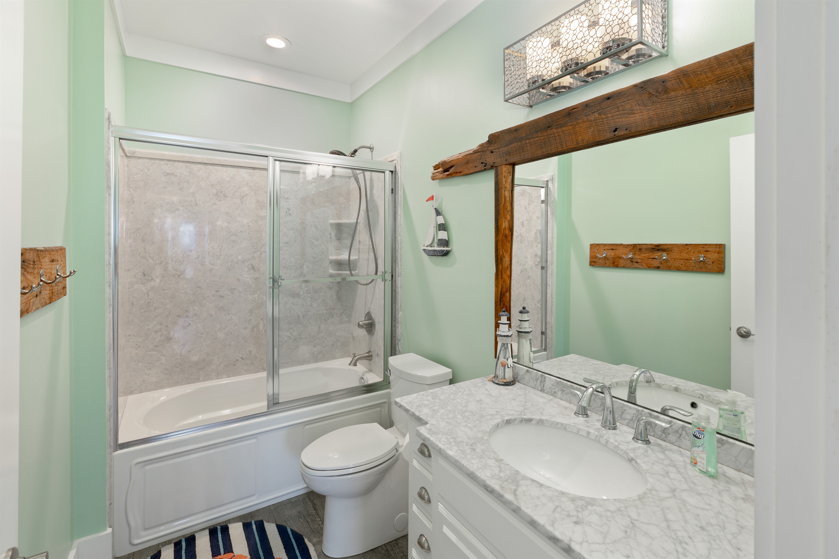 Third floor shared bathroom with shower/tub combo is utilized by the bunk rooms and common area.