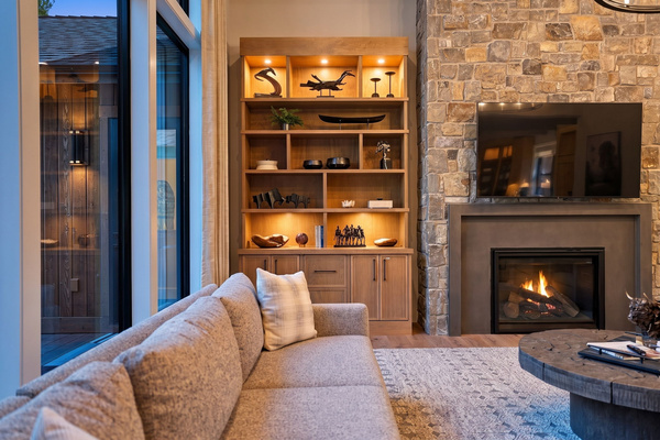 Warm evening lighting, a crackling fireplace, and a great room made for slow nights together