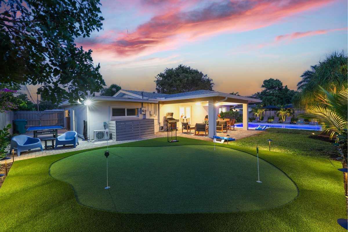 Your private Delray Beach backyard retreat brings the pool, putting green, ping pong, covered patio, and sunset lounging together in one resort-style space.