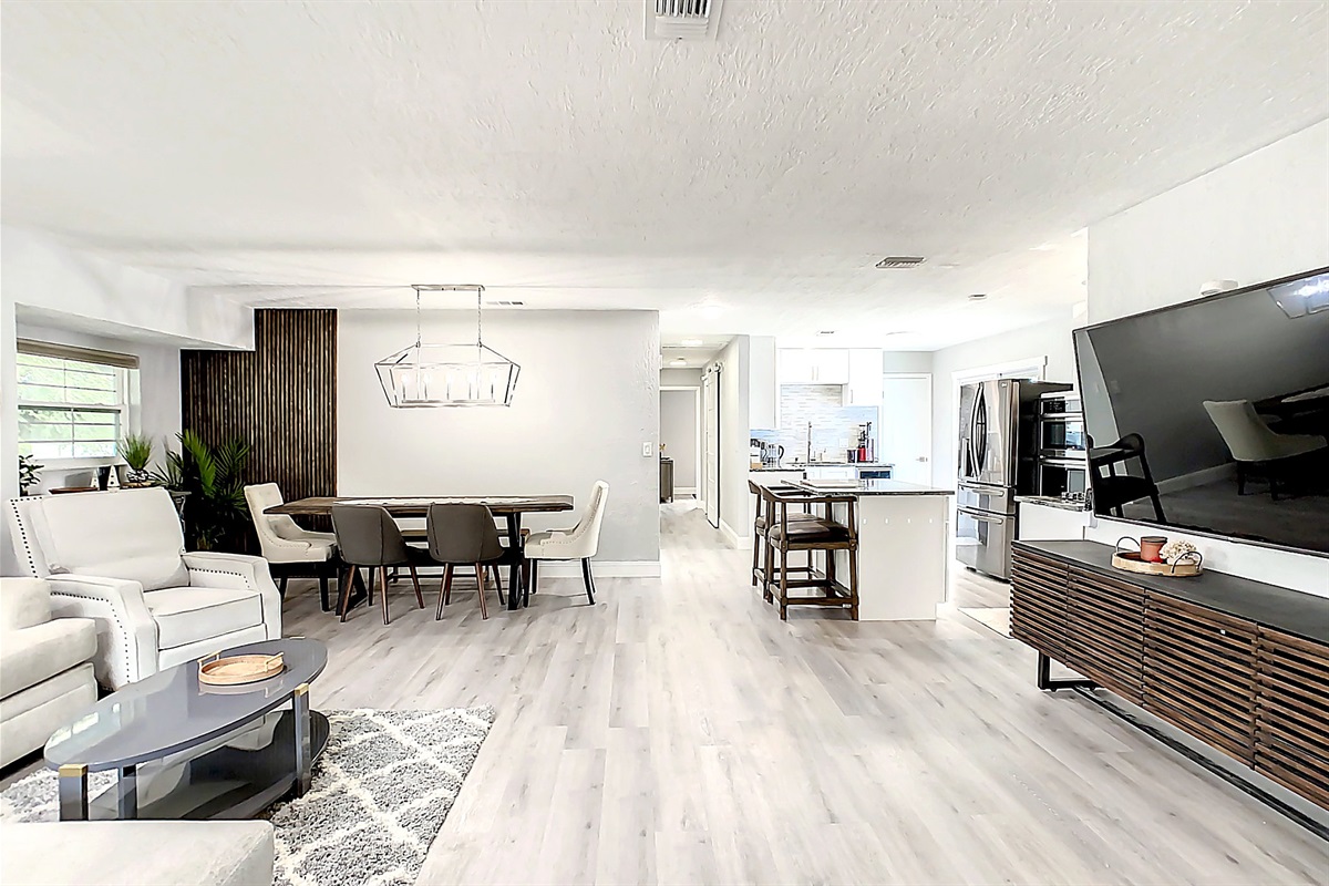 Living room with large TV and dining