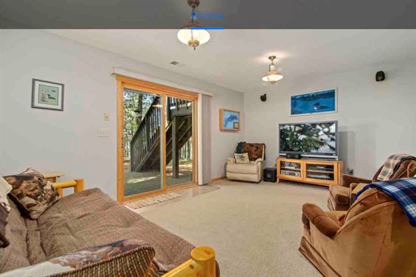 Basement living area. Walkout patio. Large TV with a futon.