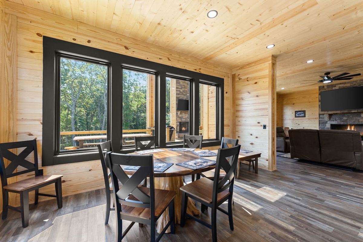  Floor-to-ceiling windows surround the dining nook, offering forest views and natural light for an unforgettable mealtime experience.