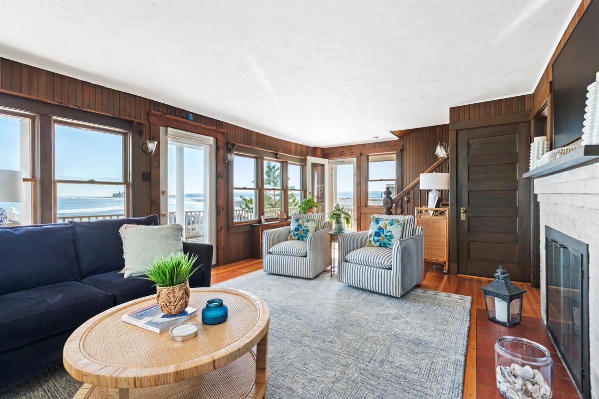Relax in a bright, cozy living room with beautiful ocean views and coastal charm. 🌊