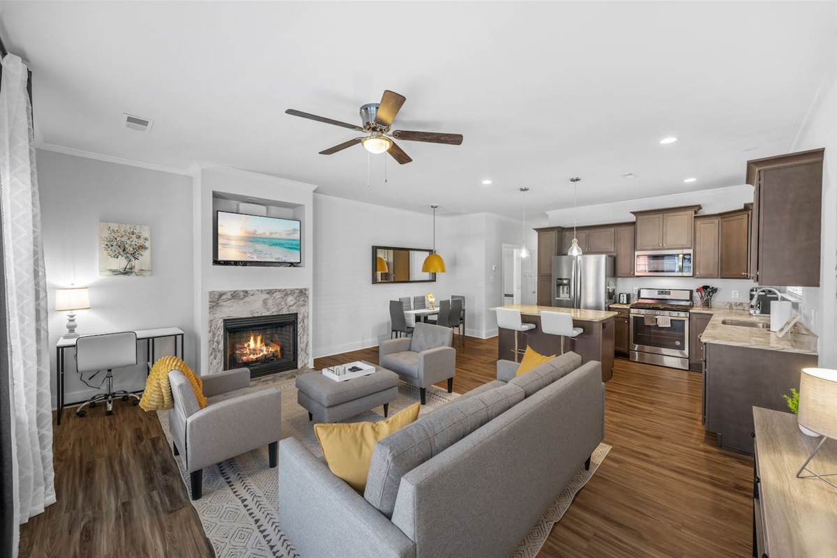 Modern décor, ceiling fan, and open flow create the perfect spot to unwind or gather together.