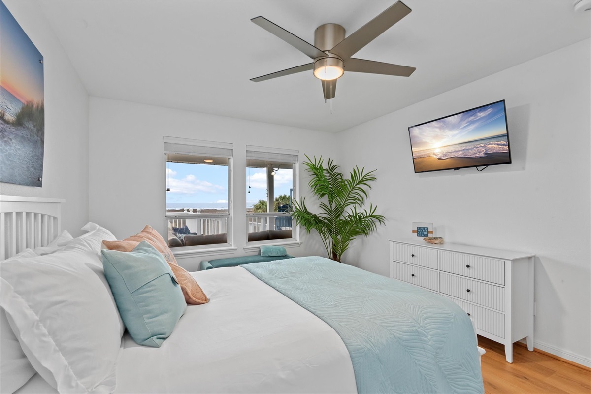 A wall-mounted TV offers the perfect setup for late-night entertainment, making it easy to unwind and relax in comfort.
