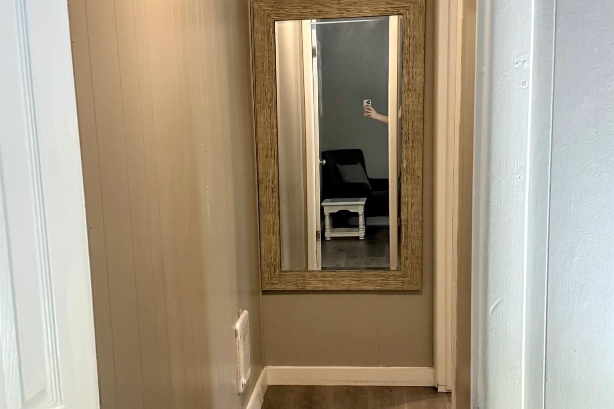 Hall leading back to daybed room with mirror.