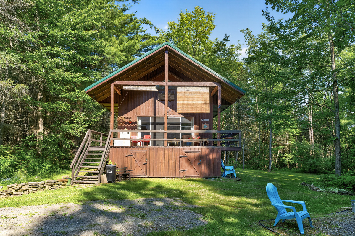 Wood cabin surrounded by mature trees