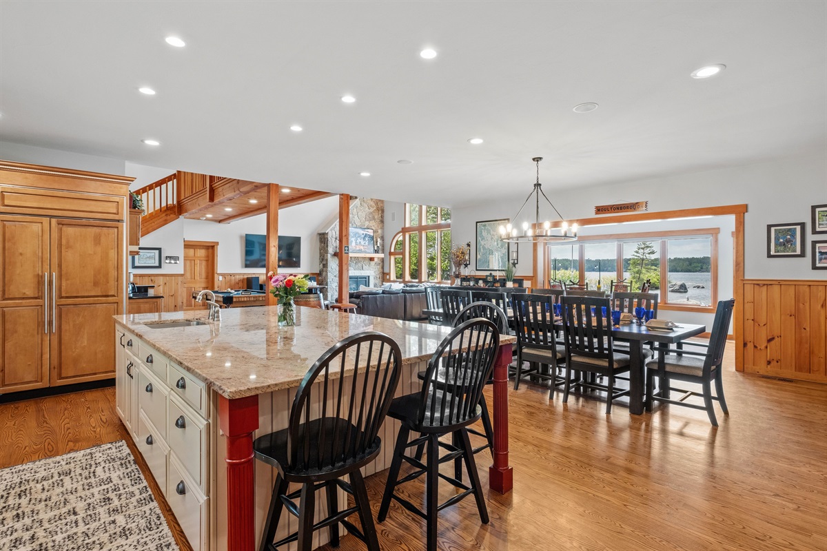 Dining area with seating for 10 plus 3 more at the kitchen island and 4 more at the barrel table near wooden posts