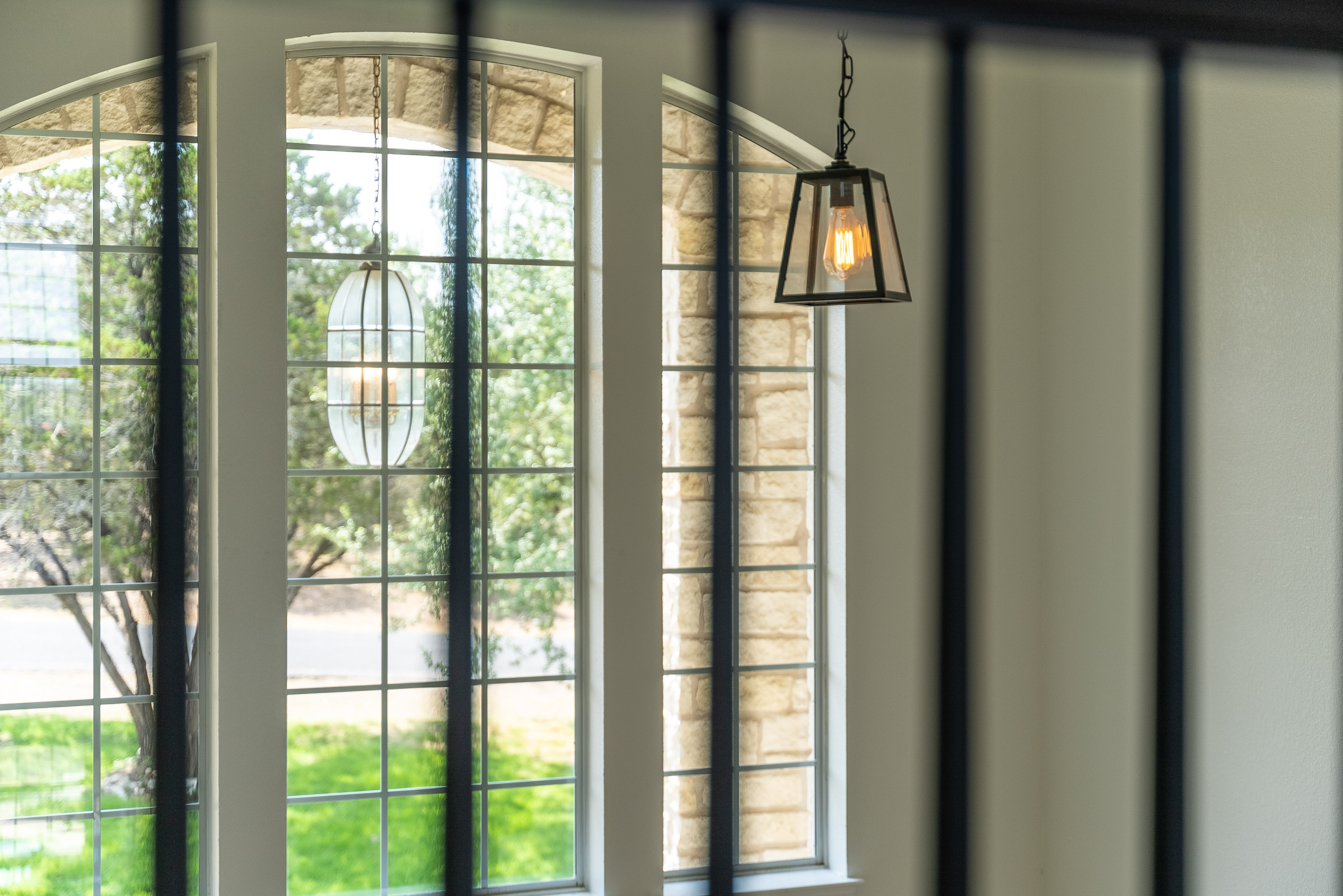 Arched windows and iron accents flood this entryway with natural charm.