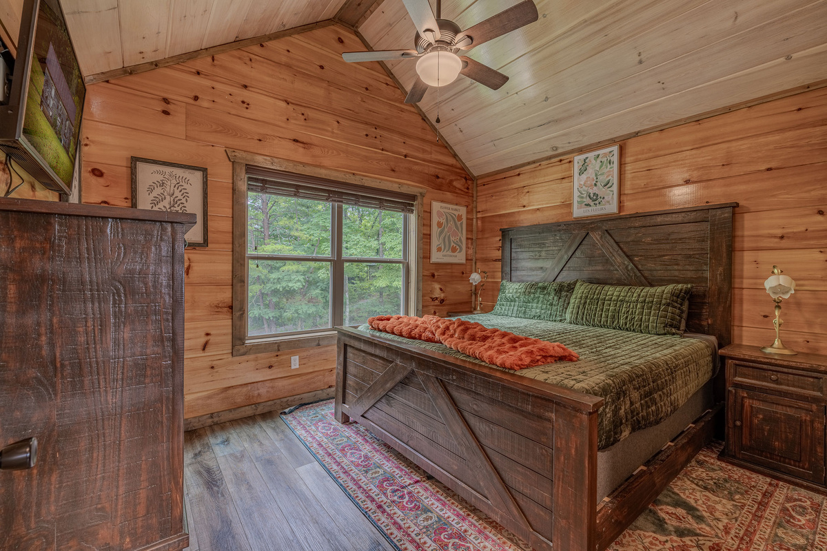 The Botanist Suite is a king bedroom with earthy style, warm wood, and restful mountain character.
