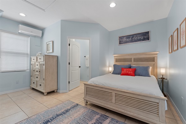 Main level ensuite queen bedroom with smart TV + direct access to pool.