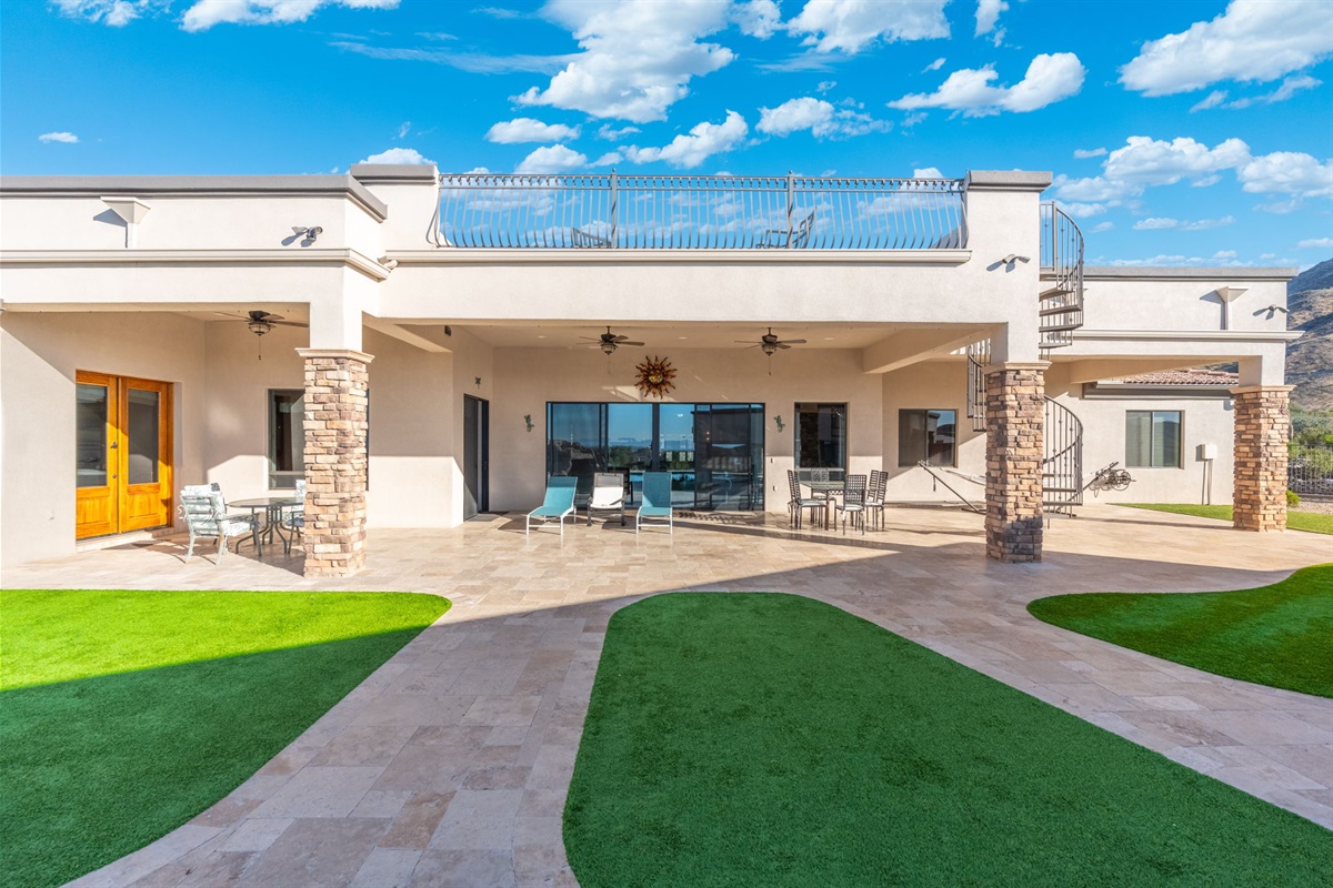 Full backyard view showcases the home’s seamless indoor-outdoor design and spacious resort-style entertaining layout