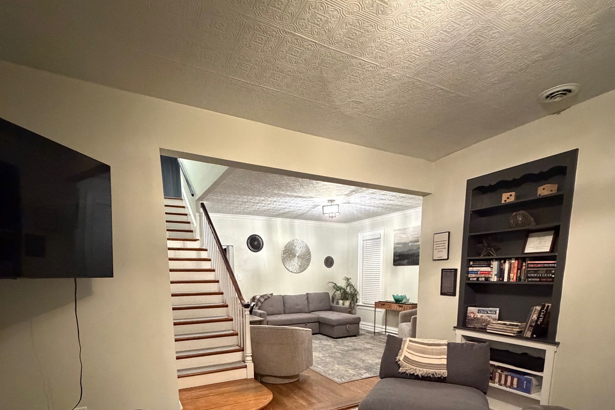 open concept lving area with plenty of seating reading lamps and natural light from surround windows.