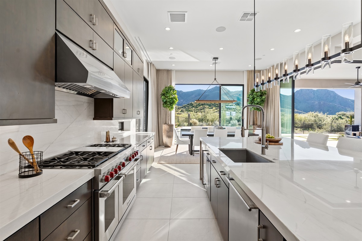 Elevate your culinary experience in this sleek, chef-inspired kitchen where modern design meets breathtaking mountain horizons.   a