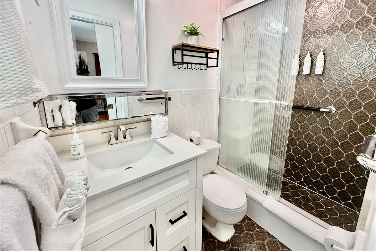 Refresh and recharge in this modern bathroom featuring luxury finishes, a glass walk-in shower, and premium bath products provided for your stay.