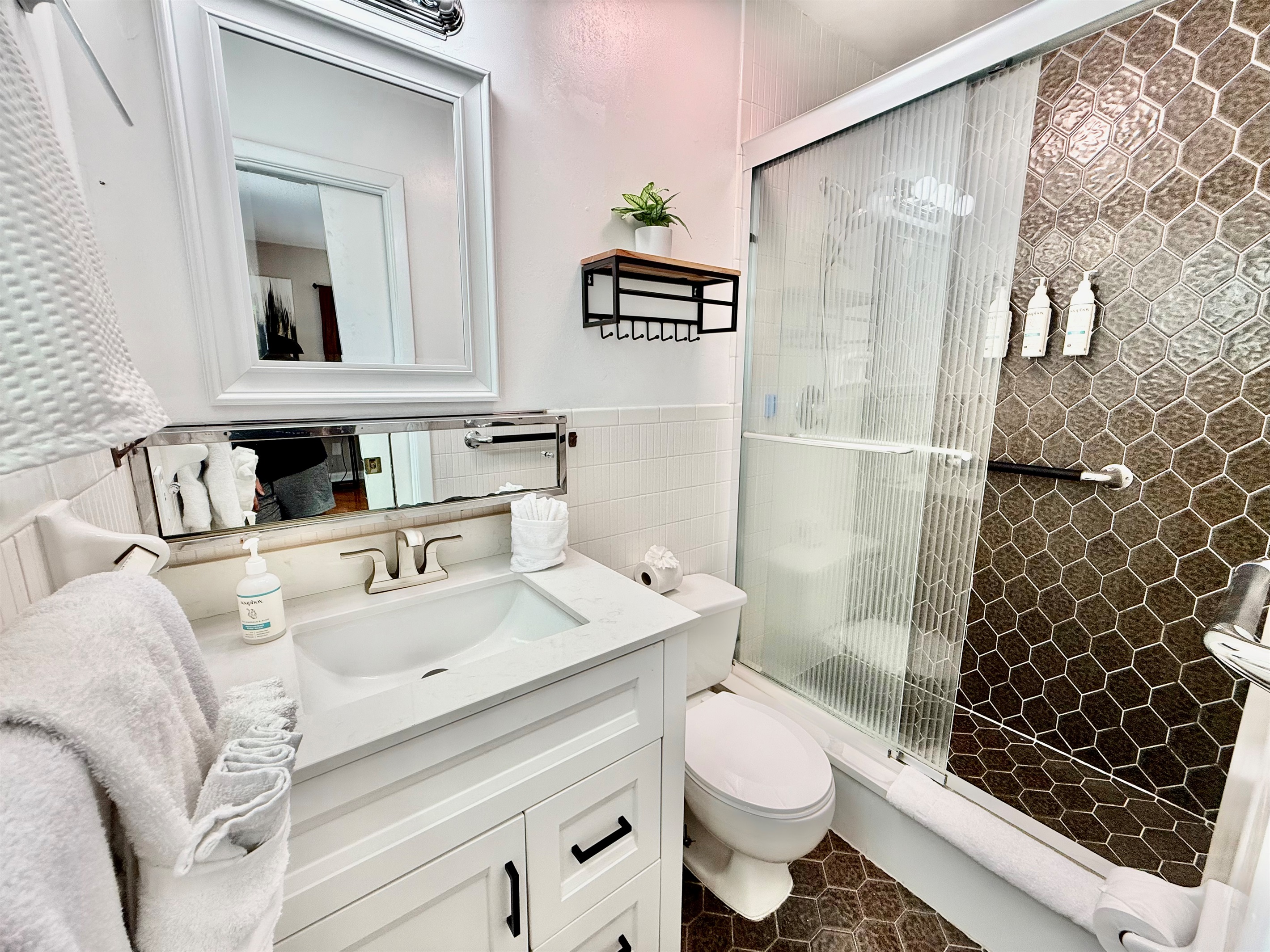 Refresh and recharge in this modern bathroom featuring luxury finishes, a glass walk-in shower, and premium bath products provided for your stay.