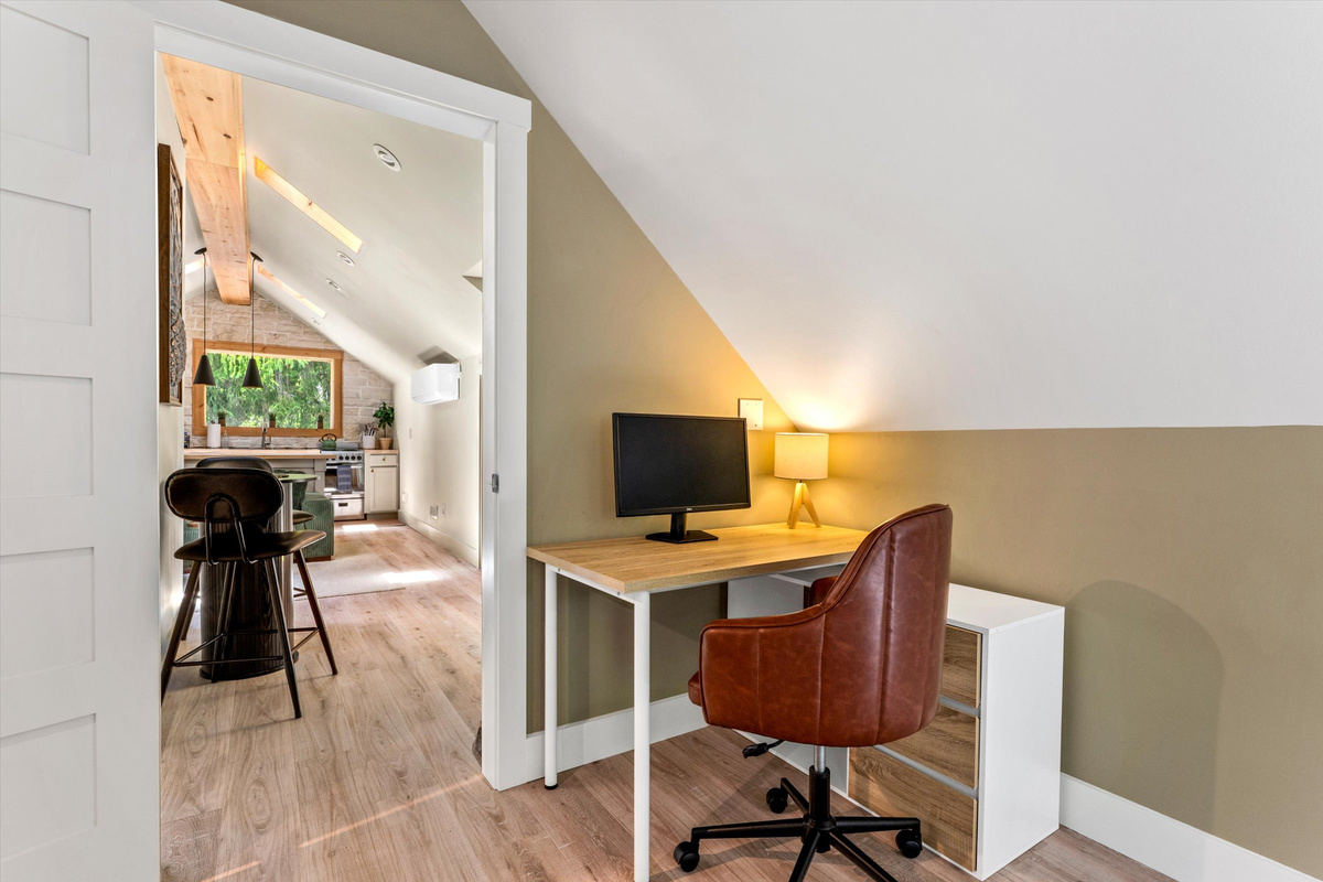 The Penthouse: Master Bedroom with King Bed, 42-inch Smart TV, Fireplace, sound machine, blackout curtains and cozy reading chair.