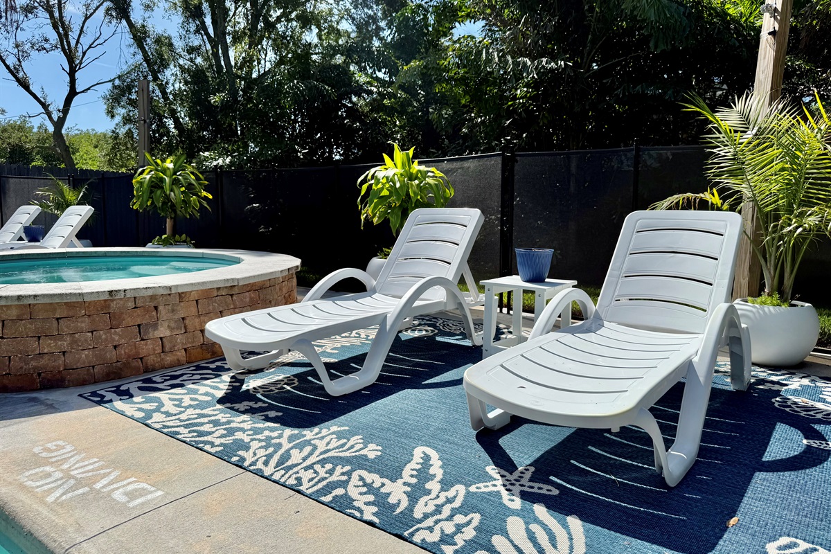 Multiple chaise loungers for sunbathing, reading, or sipping poolside drinks.