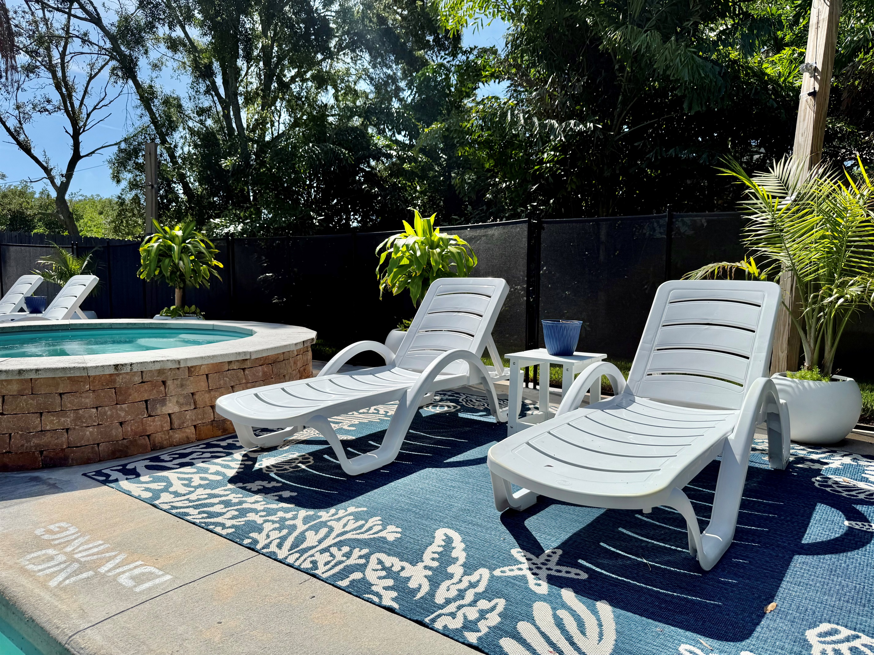 Multiple chaise loungers for sunbathing, reading, or sipping poolside drinks.