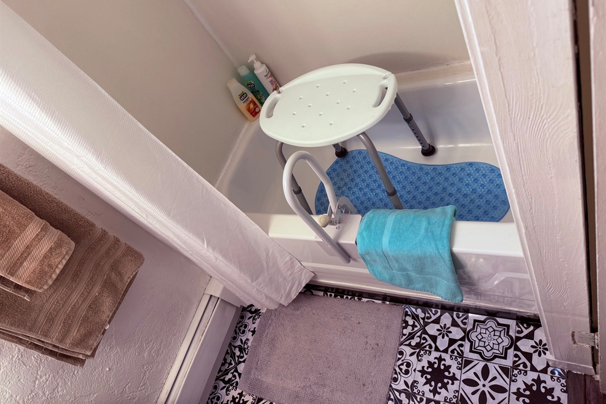 Bathroom with shower seat + mat “Accessible Tub With Safety Gear