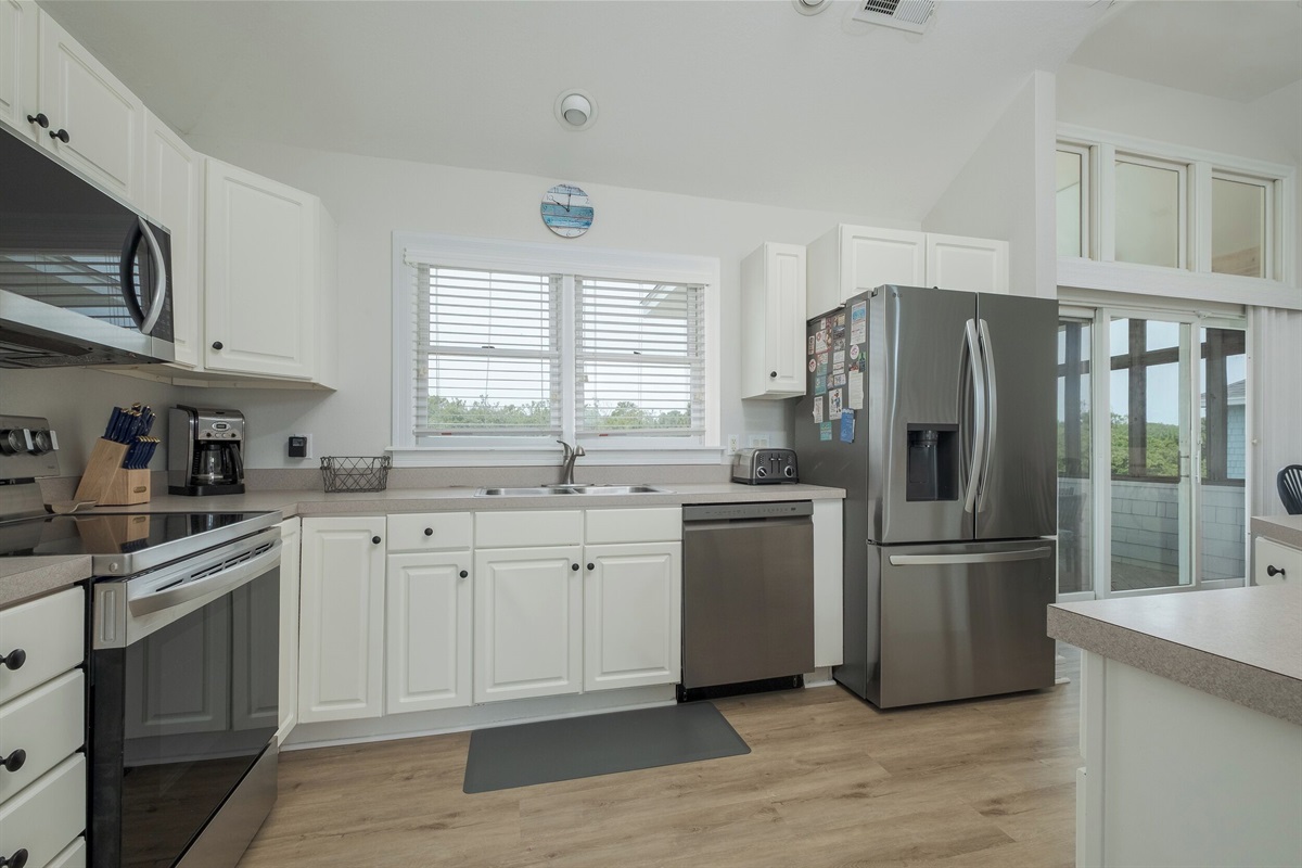 Fully stocked kitchen with stainless steel appliances and plenty of counter space for your culinary creations.