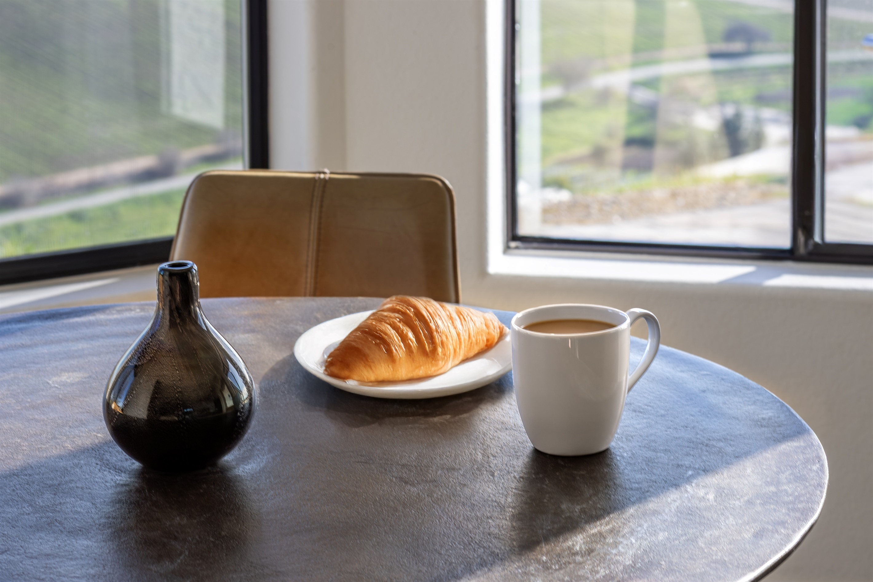 Coffee, a croissant, and a view that stretches for miles. Mornings at the Hilltop Guest House are worth waking up for.