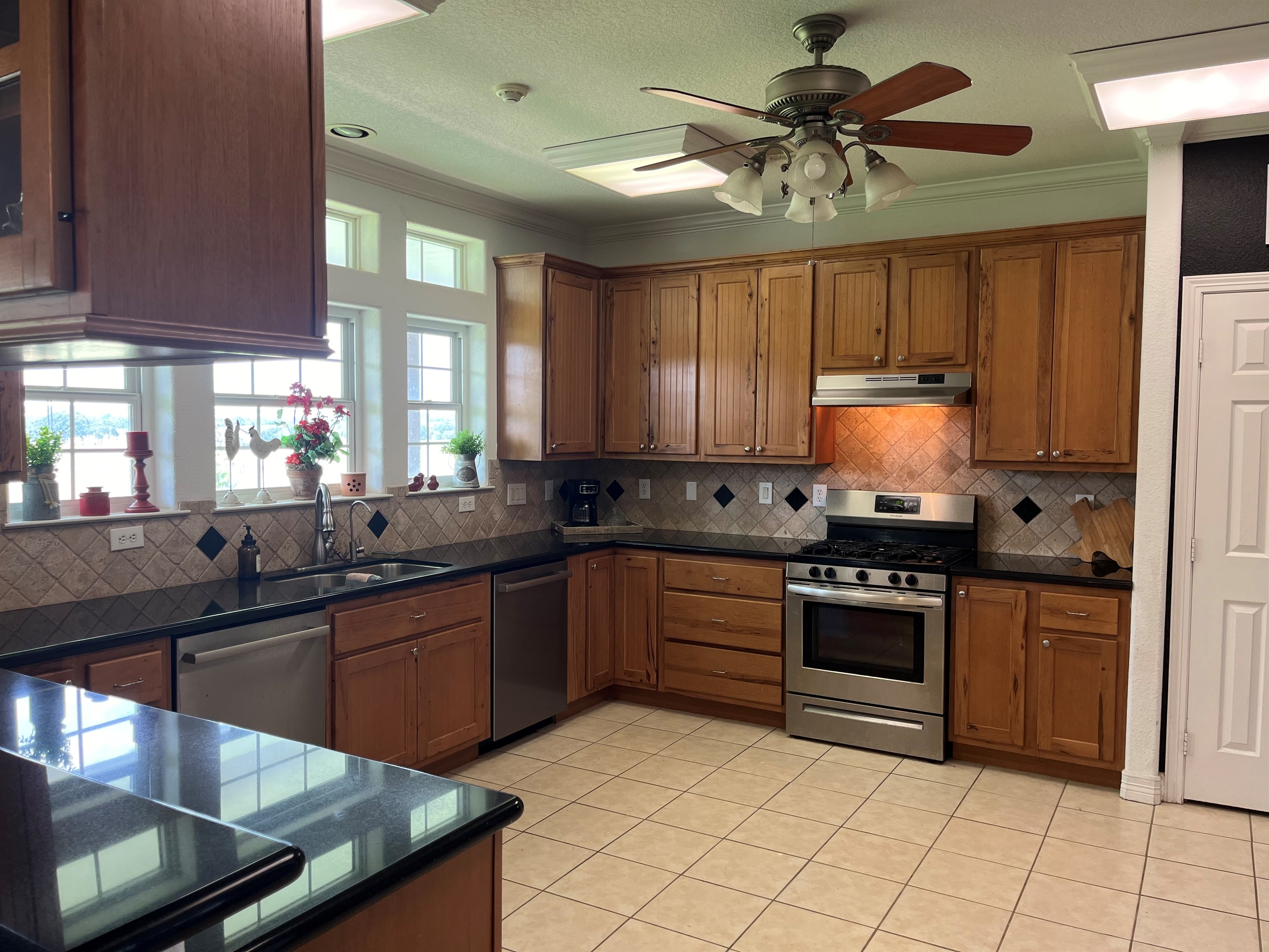two stainless steel Dishwashers and a gas stove