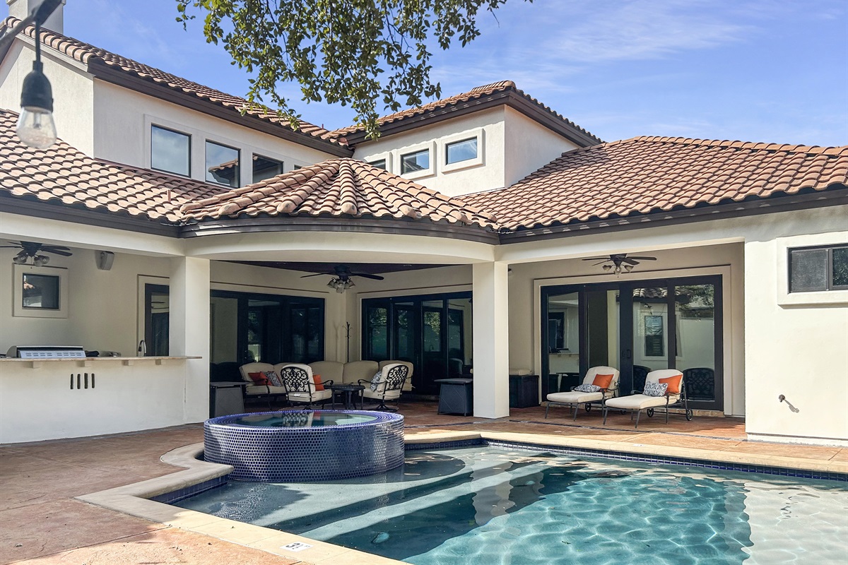 "Step into paradise with our stunning pool and expansive patio! Enjoy multiple seating areas for lounging, dining, and soaking up the sun, all complemented by a fully-equipped outdoor kitchen