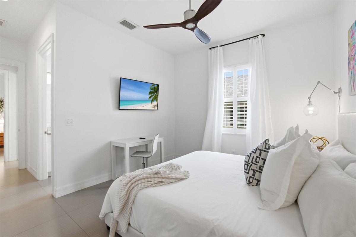 2nd master suite with king bed, private bathroom, and desk