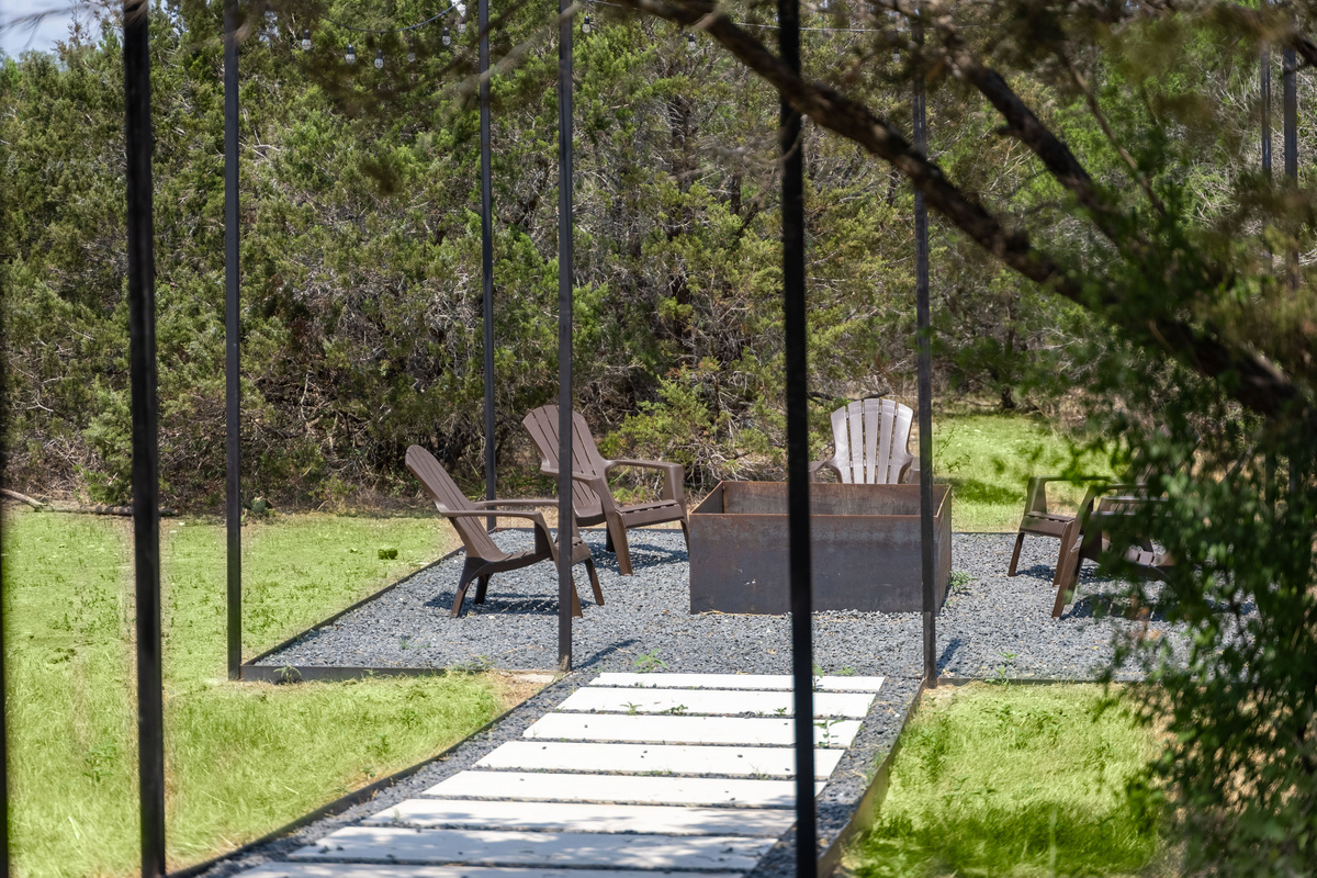 Private patio seating tucked beneath mature trees.