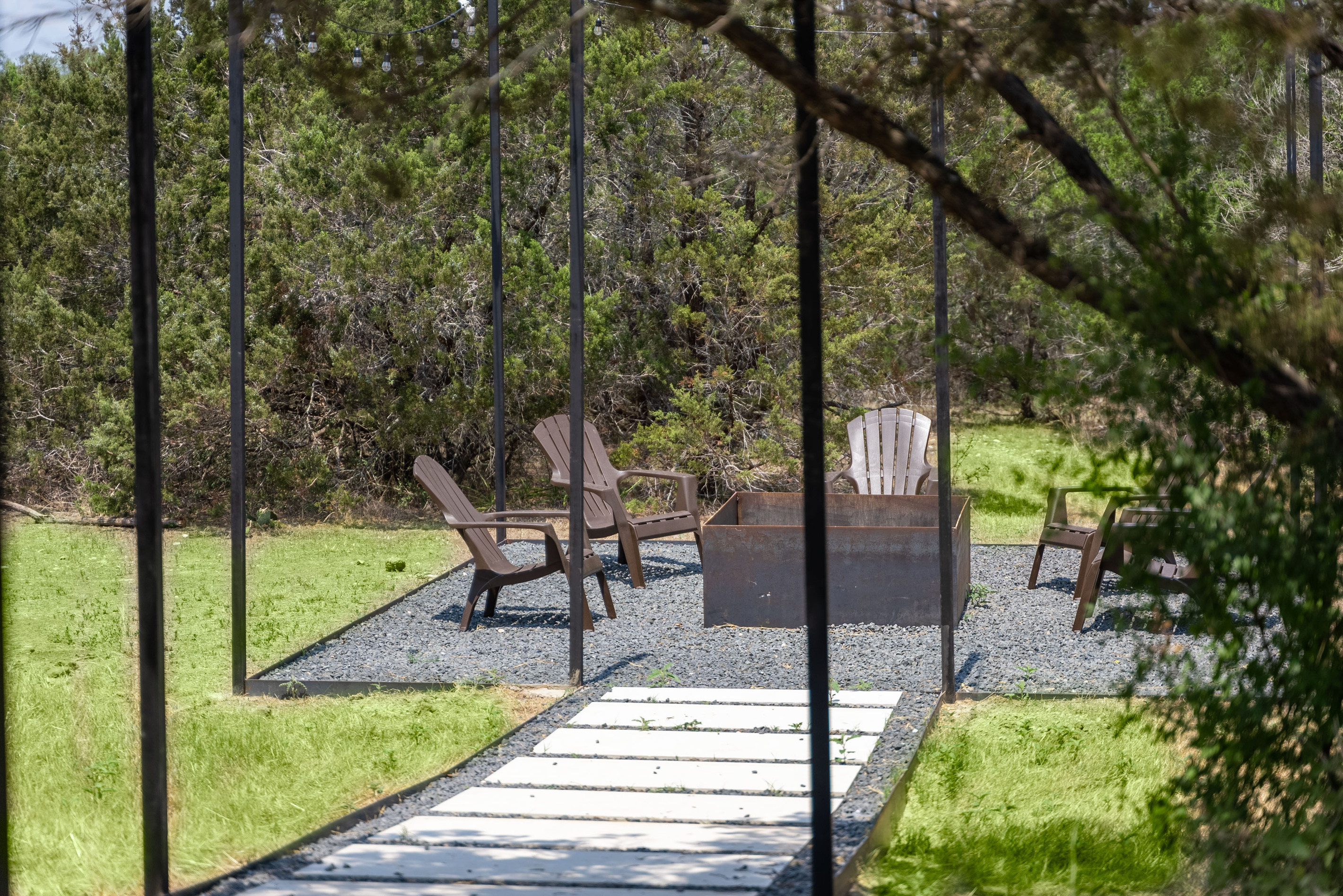 Private patio seating tucked beneath mature trees.